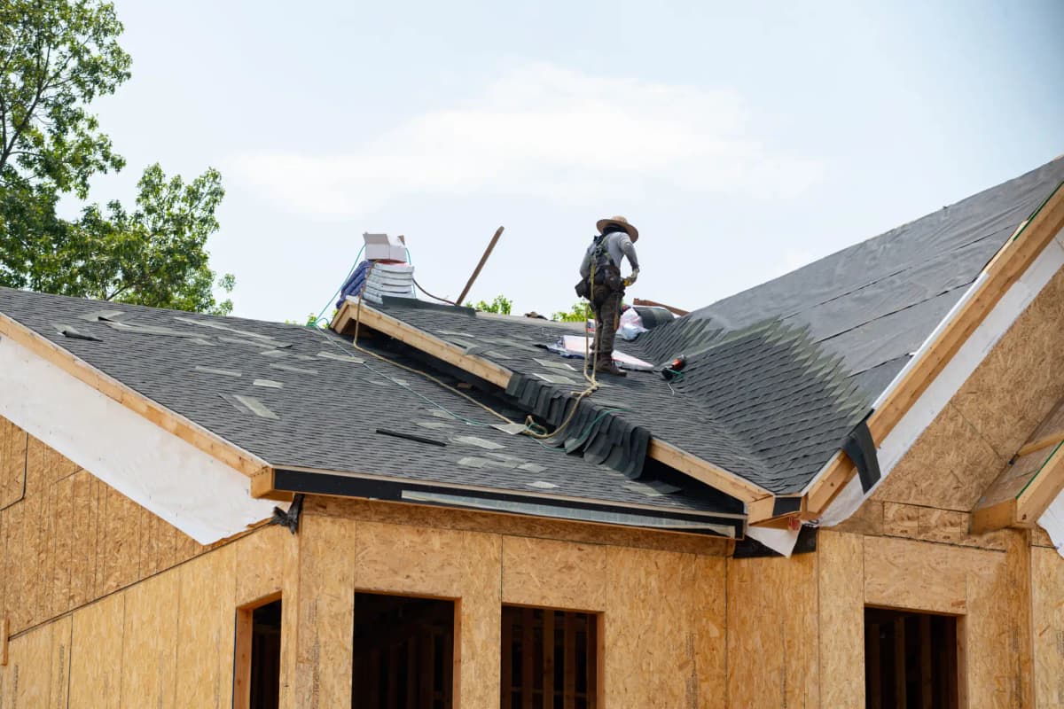 Roofers replacing a residential roof
