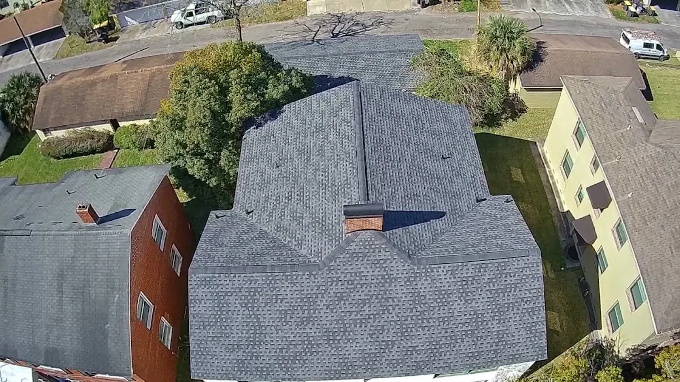 Aerial view of a gray shingle roof between neighboring homes.